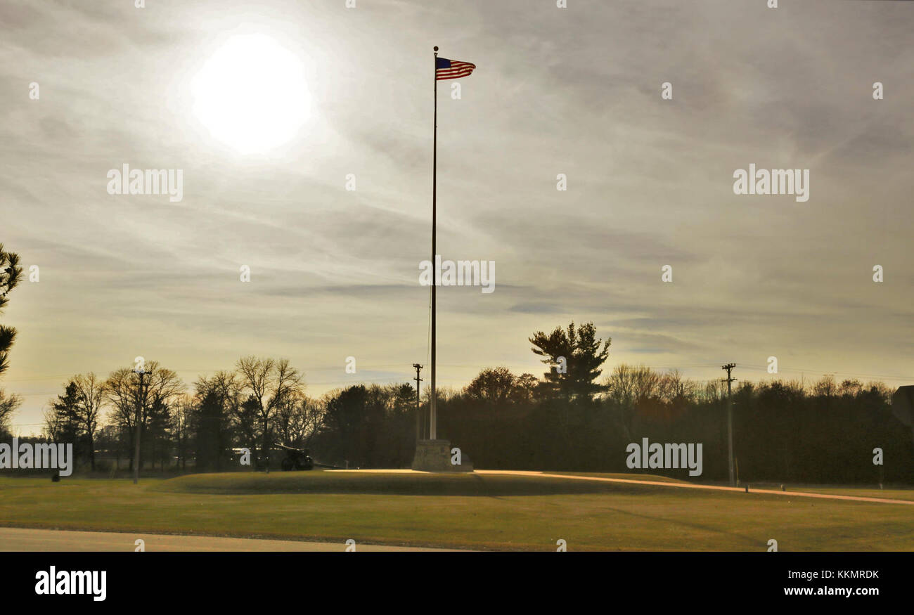 The flag of the United States of America is brightened by a backdrop of afternoon sun Nov. 27, 2017, while flying on the flagpole in front of Garrison Headquarters at Fort McCoy, Wis. The weather for late November was unseasonably warm with temperatures around 50 degrees Fahrenheit. (U.S. Army Photo by Scott T. Sturkol, Public Affairs Office, Fort McCoy, Wis.) Stock Photo