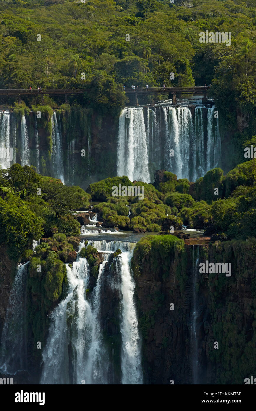 Tourists on walkway above Iguazu Falls, Argentina, seen from Brazil side, South America Stock Photo