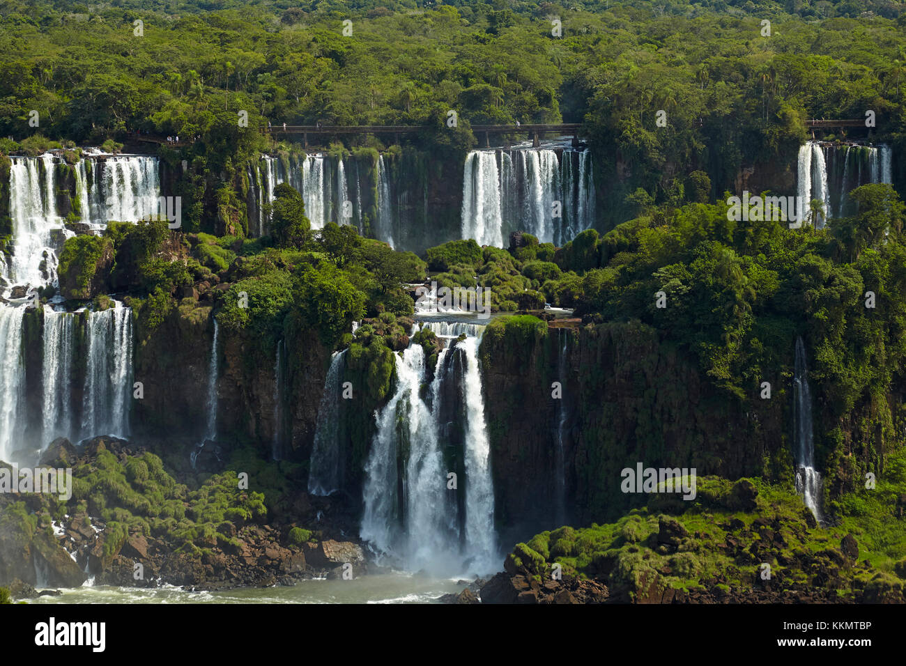 Tourists on walkway above Iguazu Falls, Argentina, seen from Brazil side, South America Stock Photo