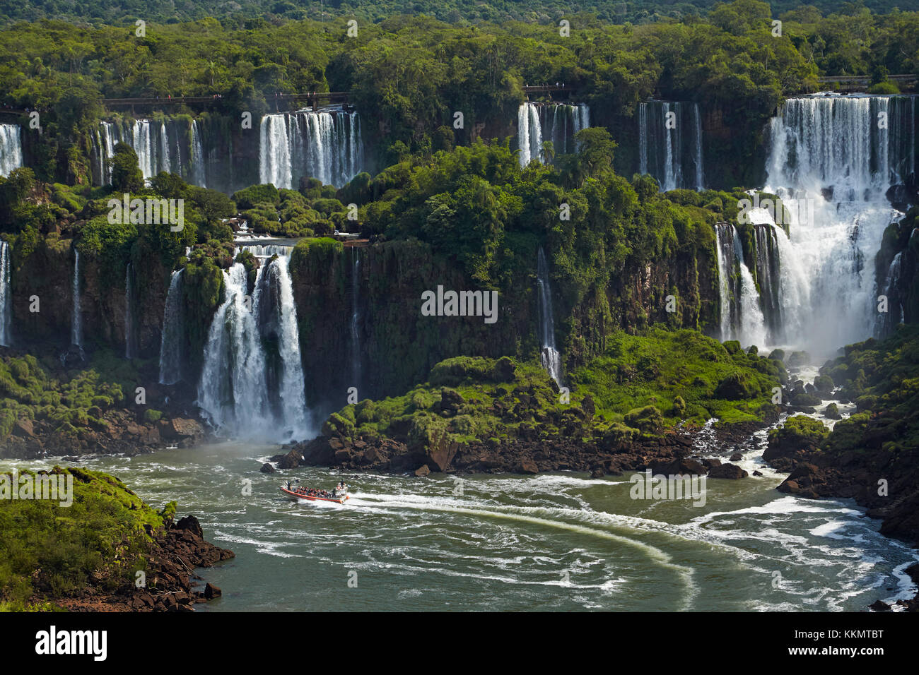 Tourists on walkway above Iguazu Falls, Argentina, seen from Brazil side, South America Stock Photo