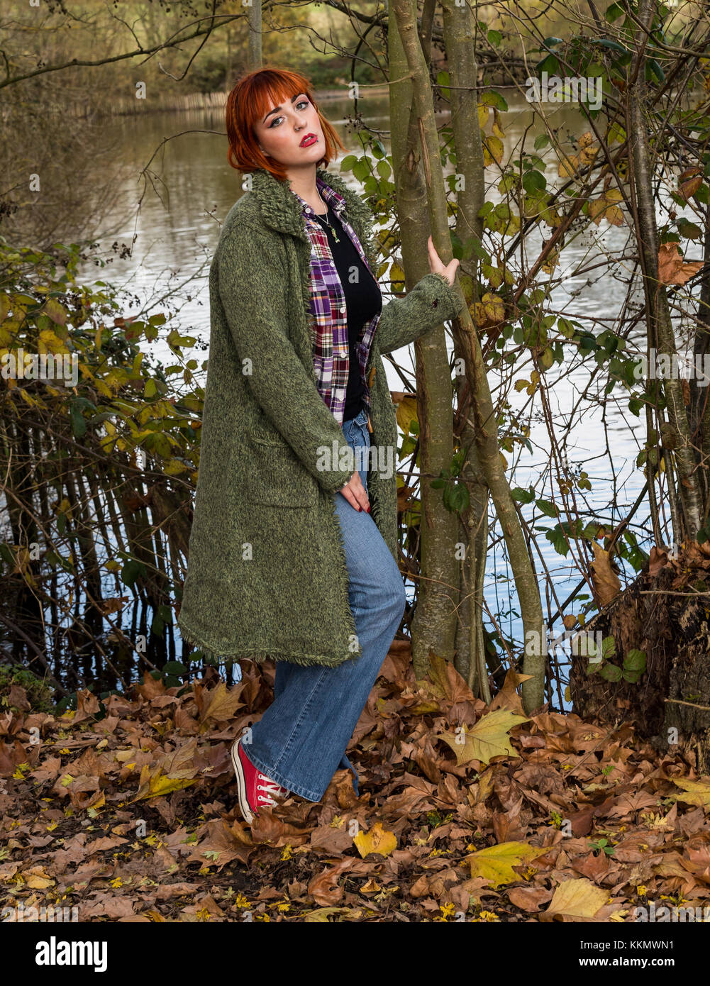 girl walking on forest path in autumn with leaves Stock Photo