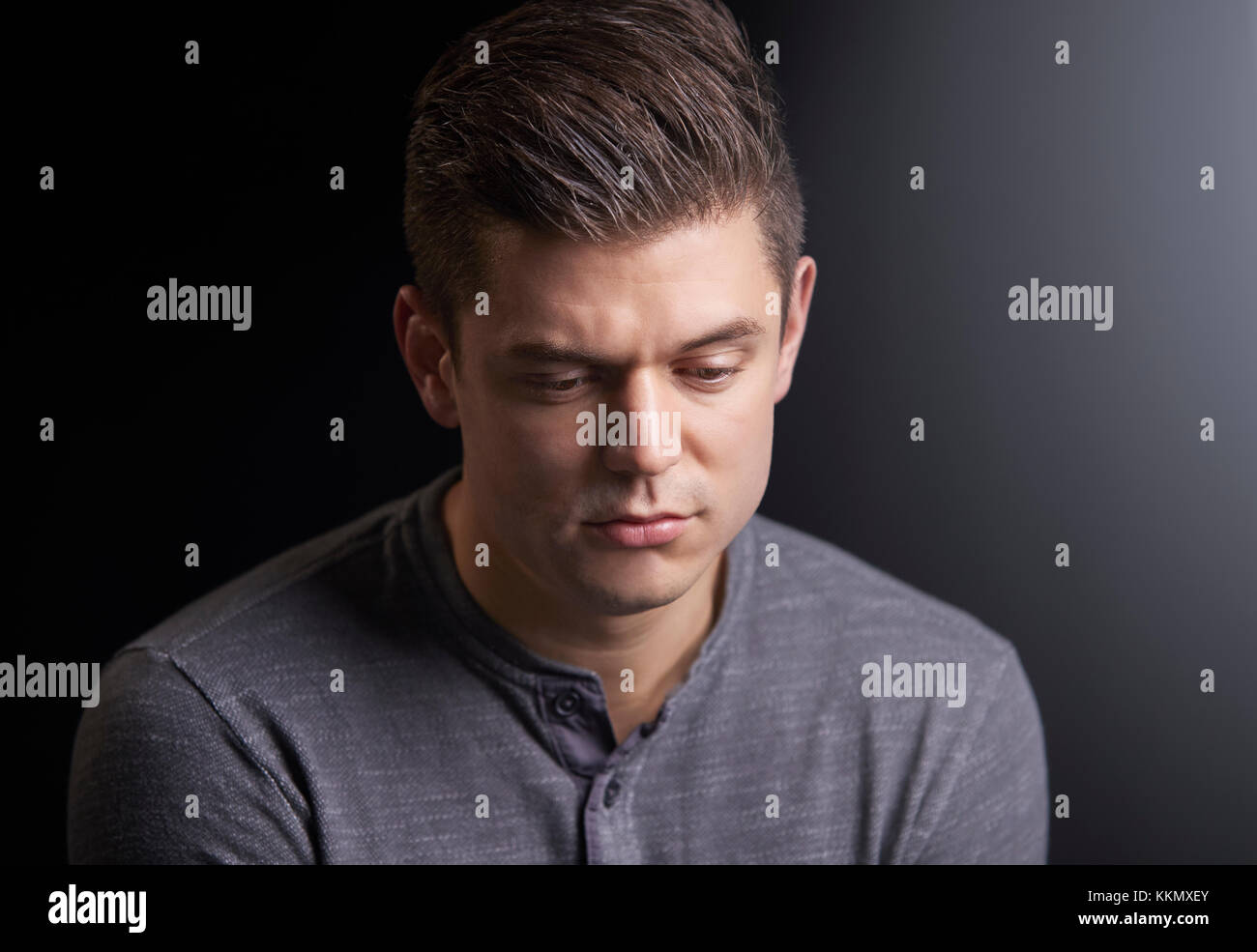 Portrait of a worried young man looking down Stock Photo