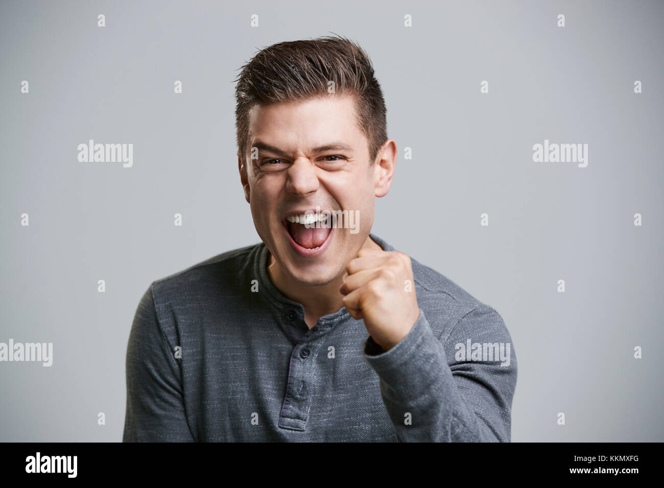 Portrait of a cheering young white man looking to camera Stock Photo