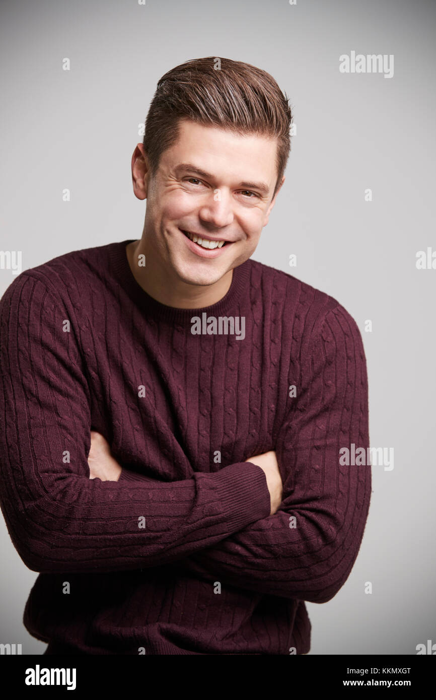 Smiling young white man with arms crossed looking to camera Stock Photo