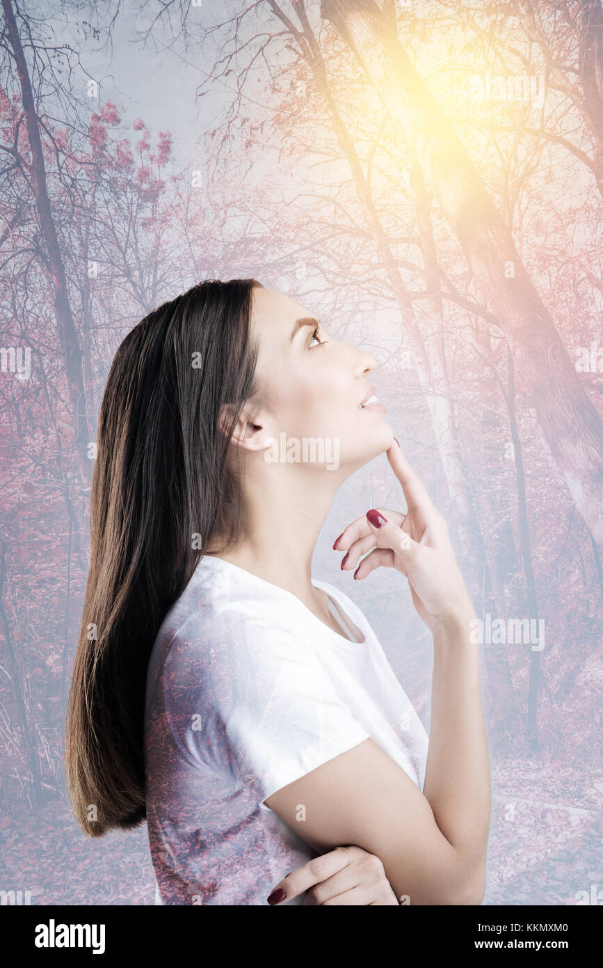 Dreamy girl raising her head Stock Photo