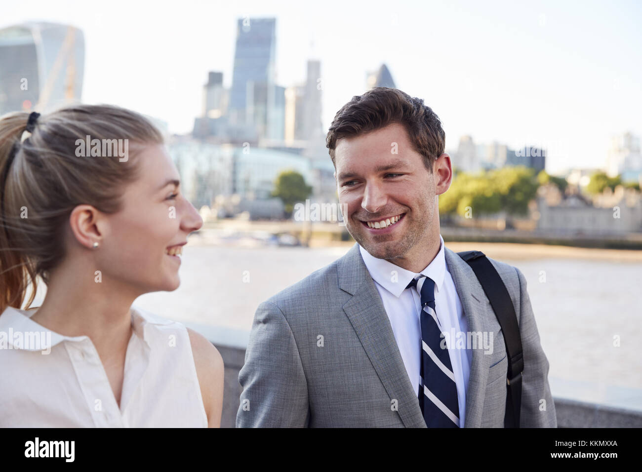 Businesspeople Walking To Work By River Thames In London Stock Photo