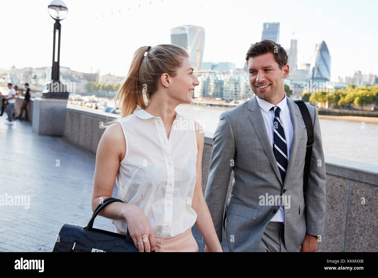 Businesspeople Walking To Work By River Thames In London Stock Photo