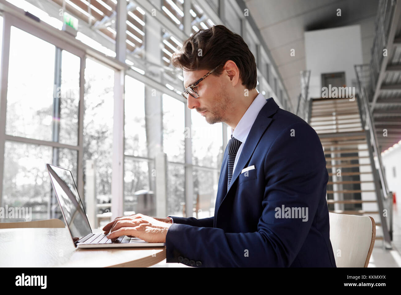 Young professional man using laptop, close up Stock Photo