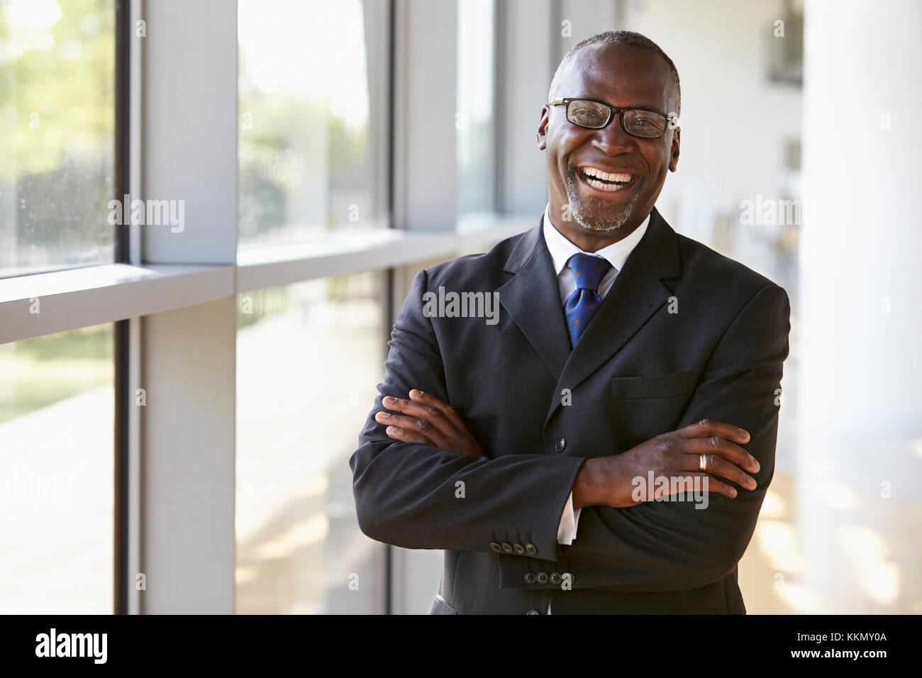 Portrait of a smiling businessman with arms crossed Stock Photo - Alamy