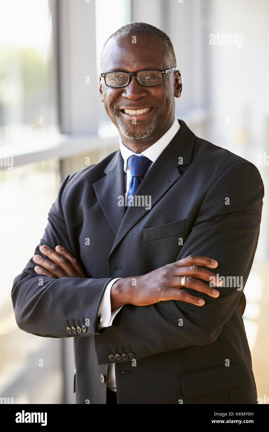 Portrait of a smiling businessman with arms crossed Stock Photo - Alamy
