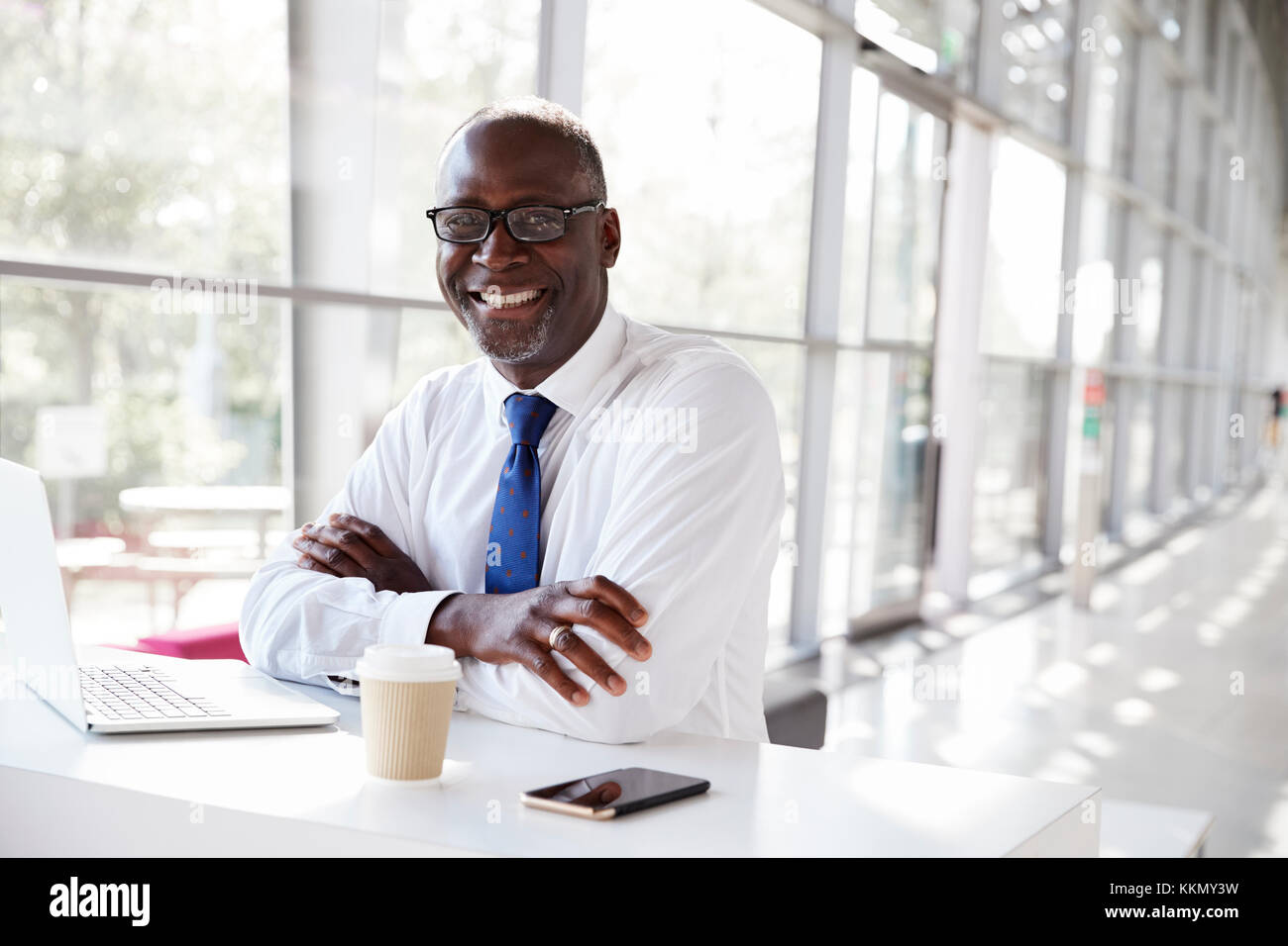 Portrait of a black businessman sitting at a desk Stock Photo