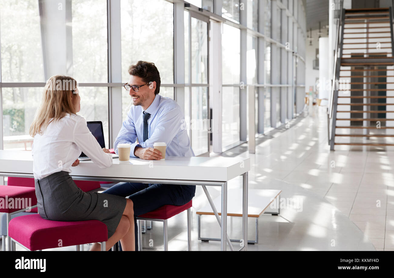 Businesswoman and businessman talking at a meeting Stock Photo - Alamy
