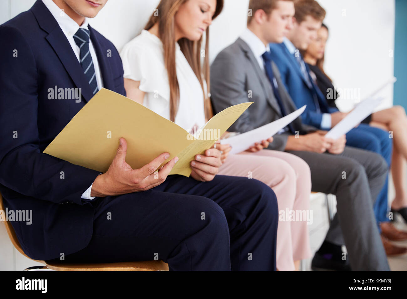 Candidates waiting for job interviews, mid section Stock Photo