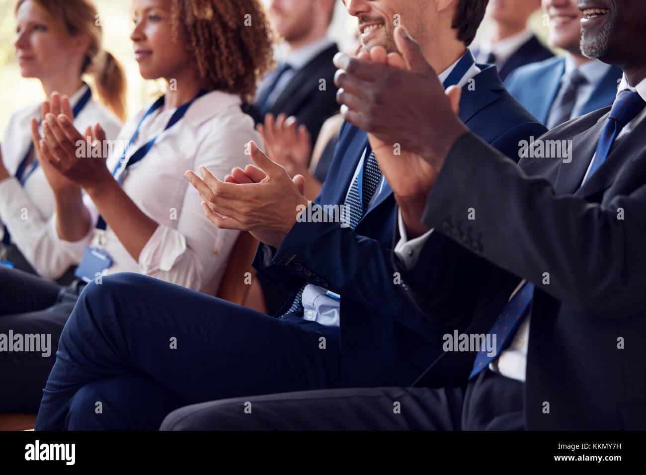 Mid section of applauding audience at business seminar Stock Photo