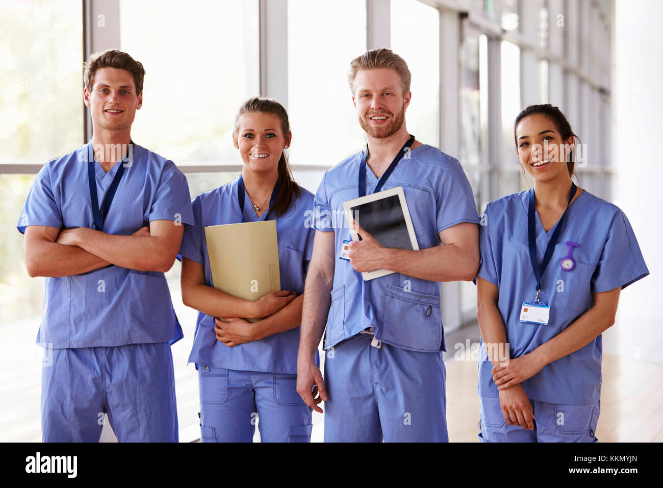 Group portrait of healthcare workers in hospital corridor Stock Photo