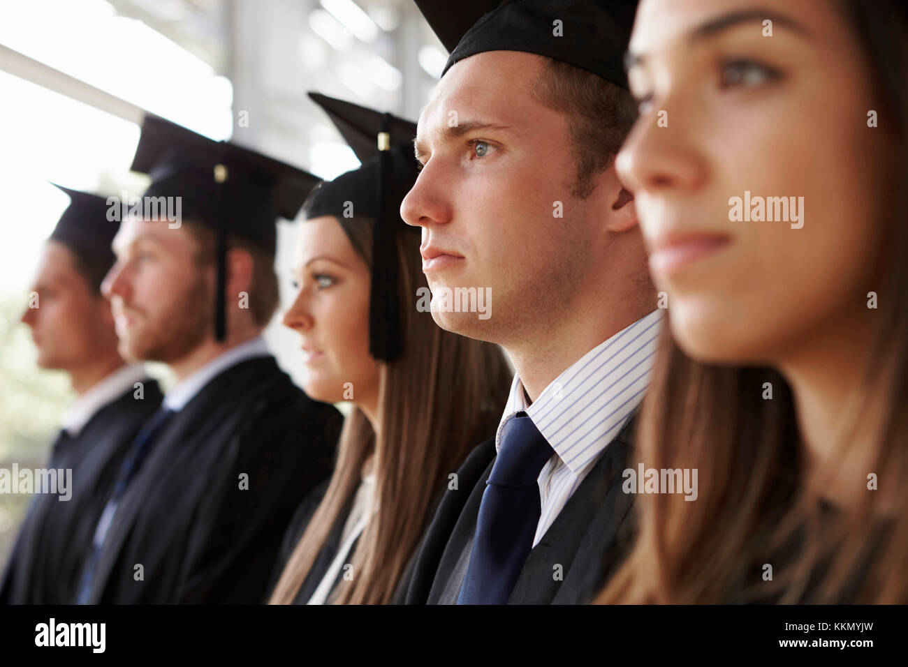 Serious graduates in mortars and gowns, head and shoulders Stock Photo ...