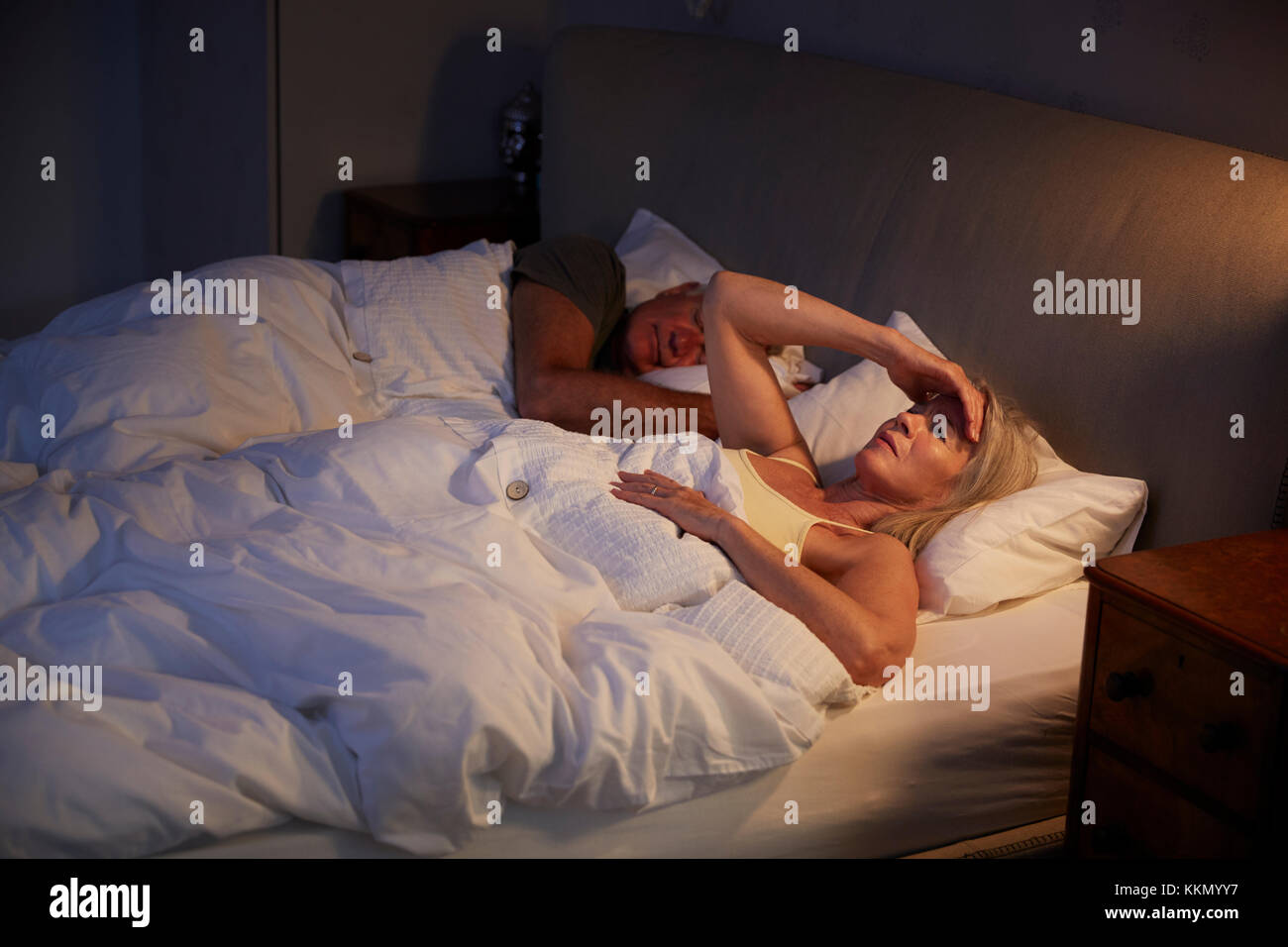 Worried Senior Woman In Bed At Night Suffering With Insomnia Stock Photo