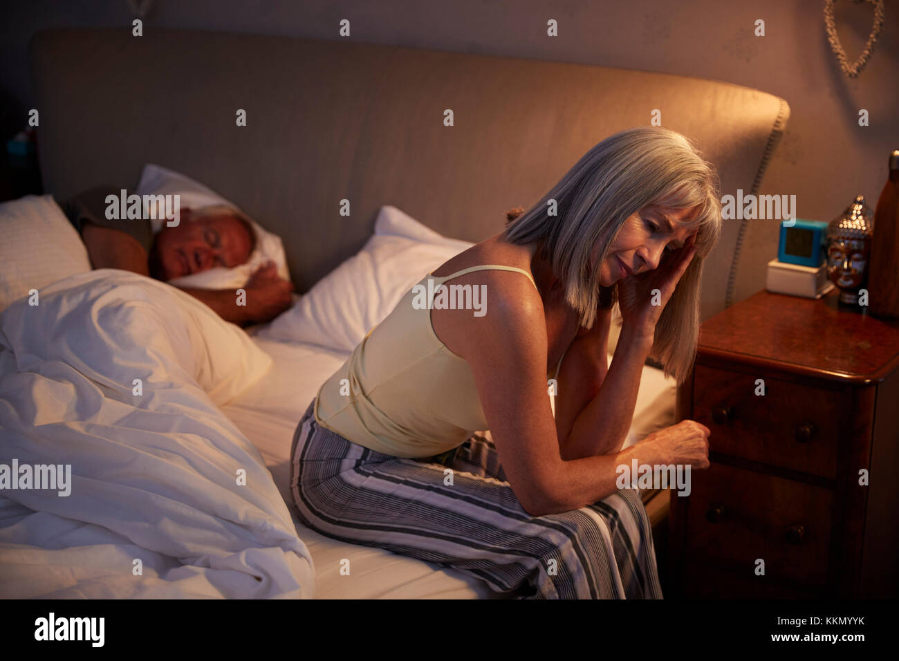 Worried Senior Woman In Bed At Night Suffering With Insomnia Stock Photo