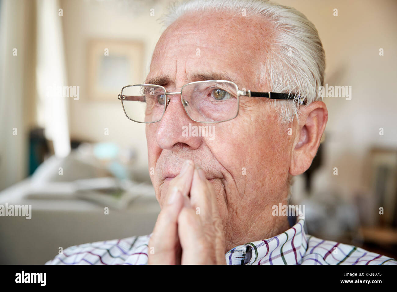 Close up of contemplative senior man at home Stock Photo