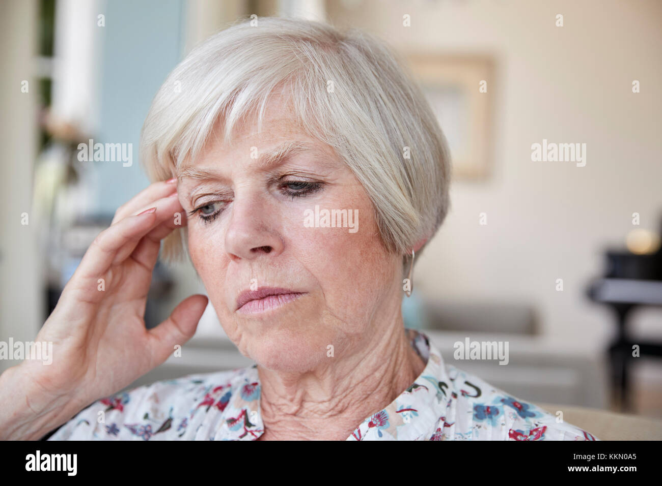 Contemplative senior woman at home, close up Stock Photo