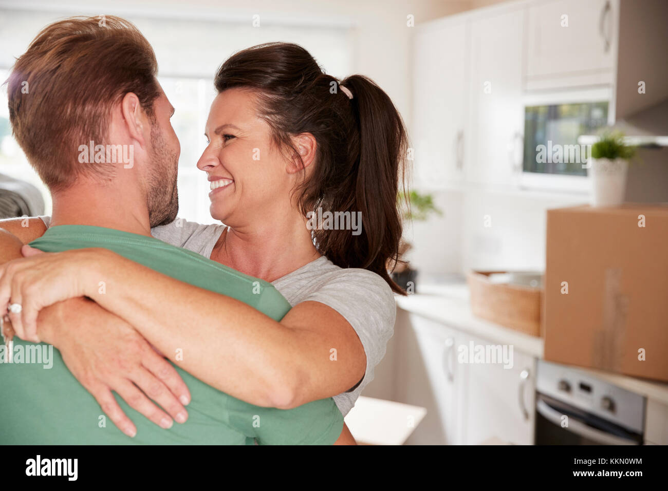 Loving Couple Celebrating Engagement At Home Stock Photo