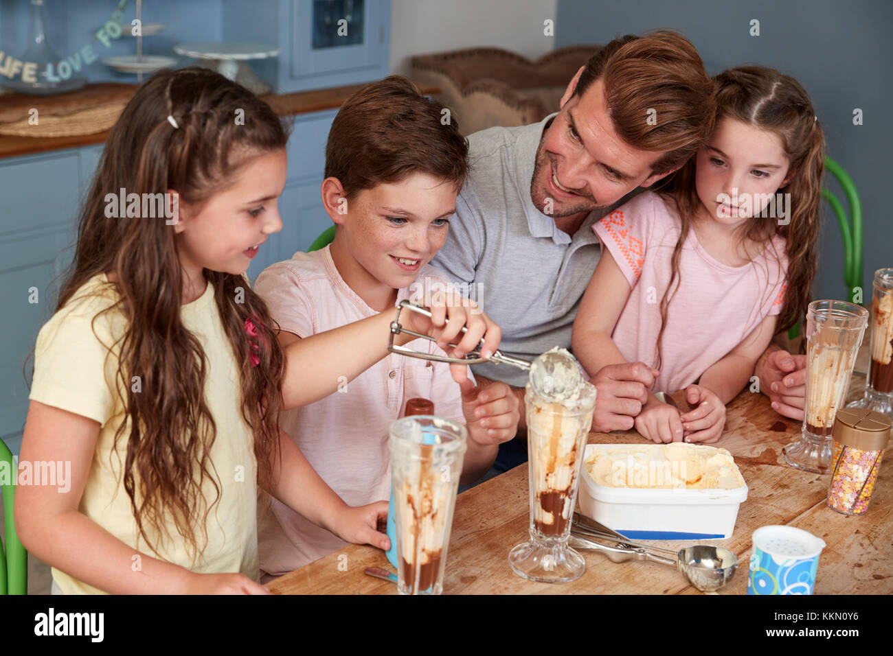 Father Making Ice Cream Sundaes With Children At Home Stock Photo Alamy