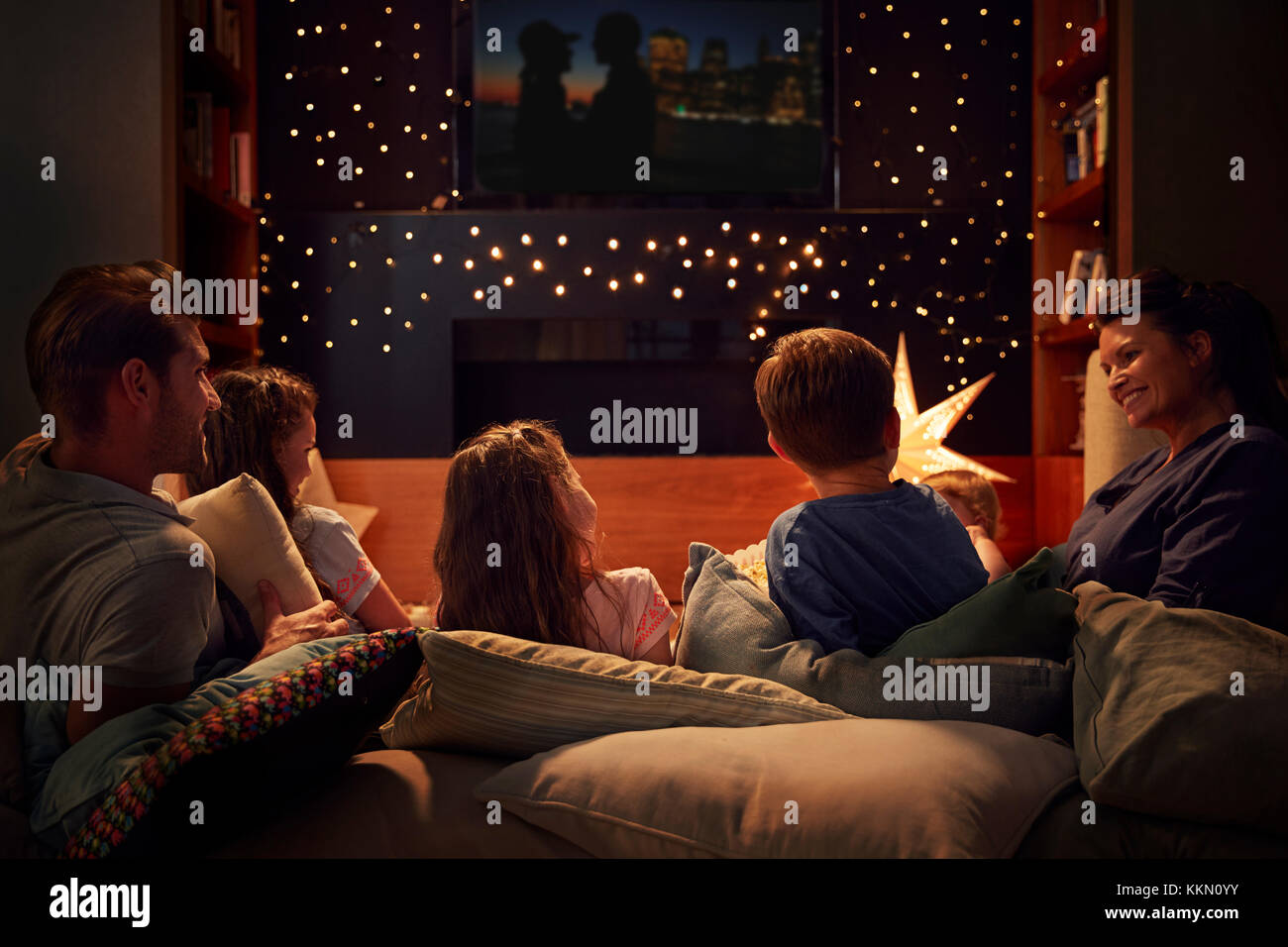 Family Enjoying Movie Night At Home Together Stock Photo - Alamy
