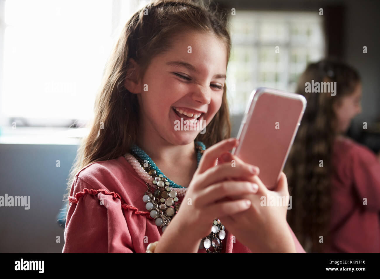 Girl Playing Dressing Up Game Taking Selfie On Mobile Phone Stock Photo