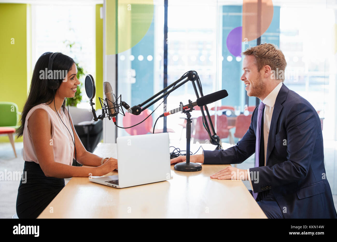 Young woman interviewing a guest in a studio for a podcast Stock Photo