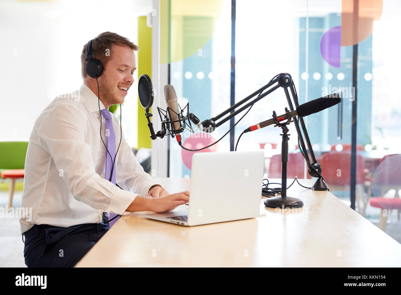 Happy young man recording a podcast, close up Stock Photo