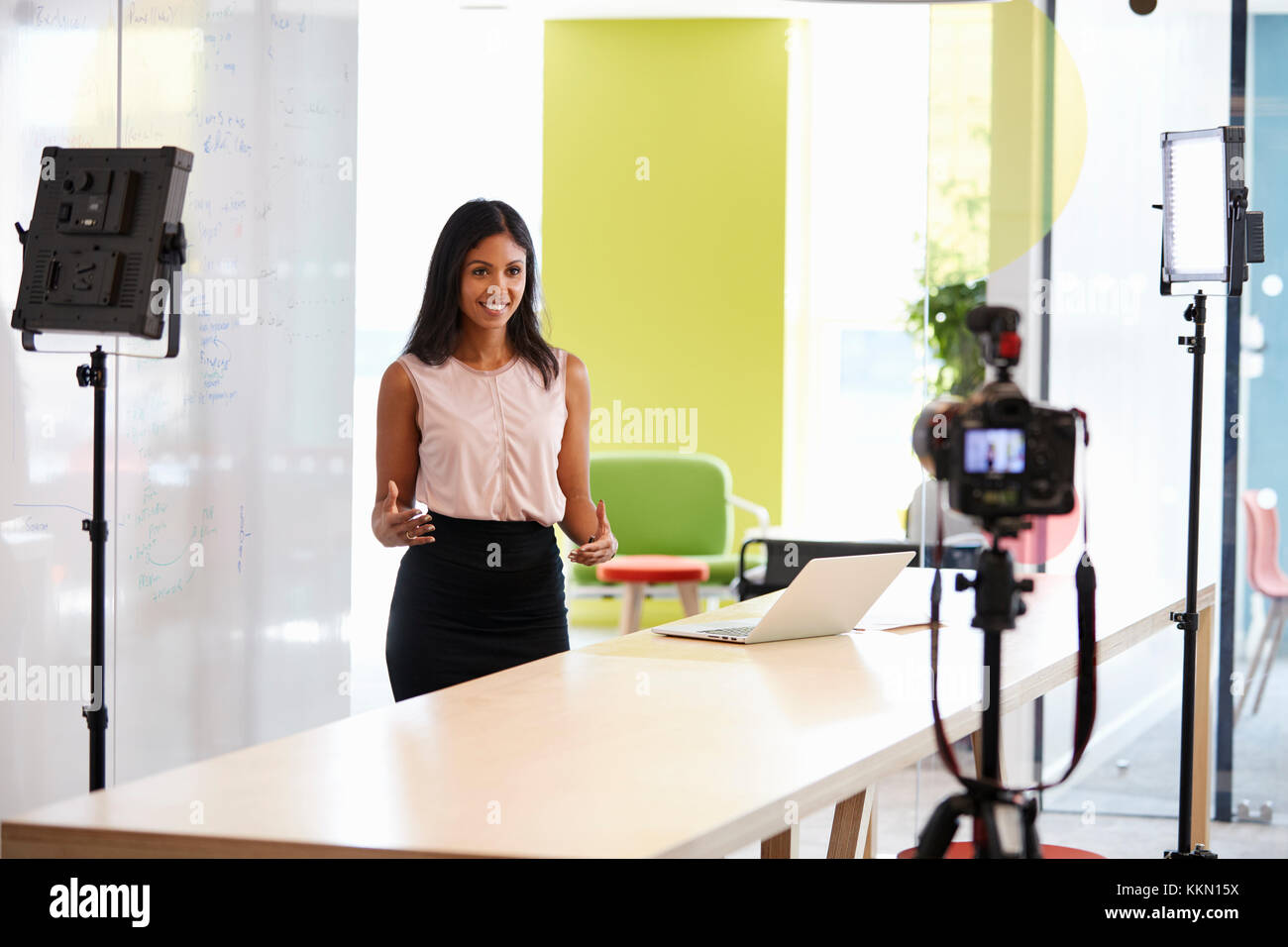 Young woman making a corporate demonstration video Stock Photo