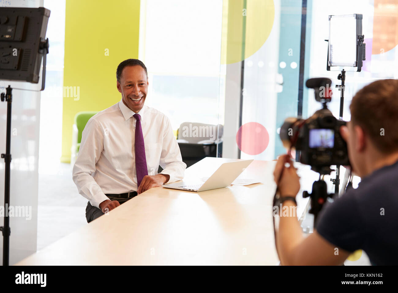 Cameraman and middle aged businessman making corporate video Stock Photo