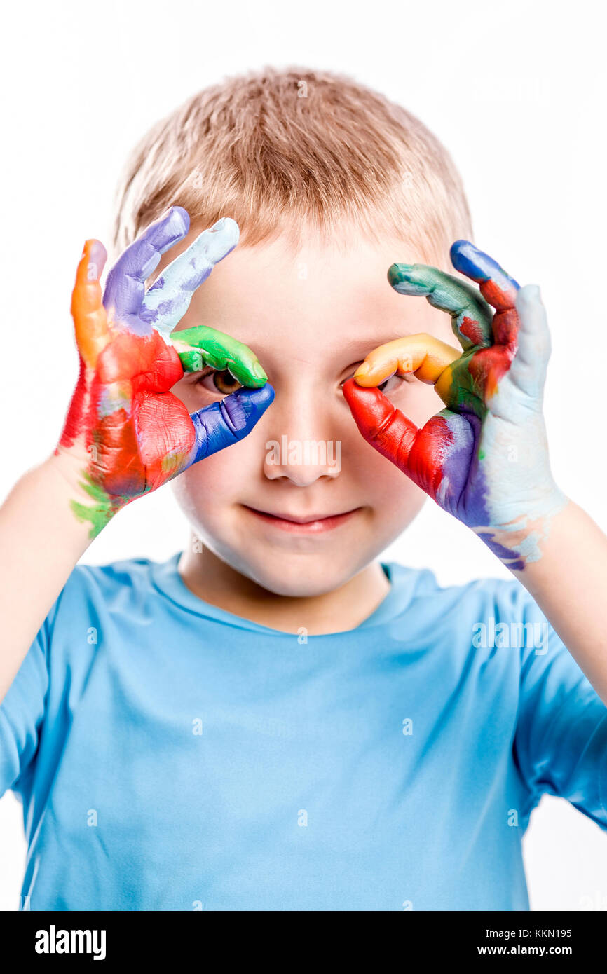 portrait of caucasian child with painted hands isolated on white background Stock Photo