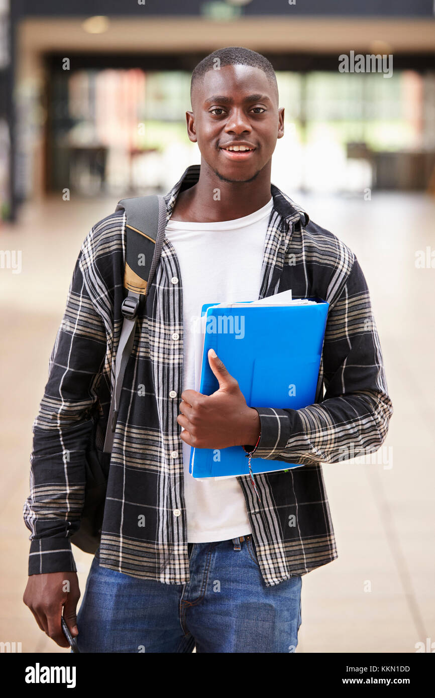 Portrait Of Male Student Standing In College Building Stock Photo