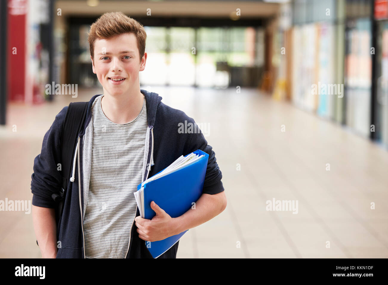Portrait Of Male Student Standing In College Building Stock Photo - Alamy