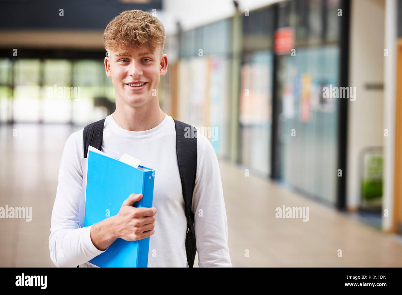 Portrait Of Male Student Standing In College Building Stock Photo