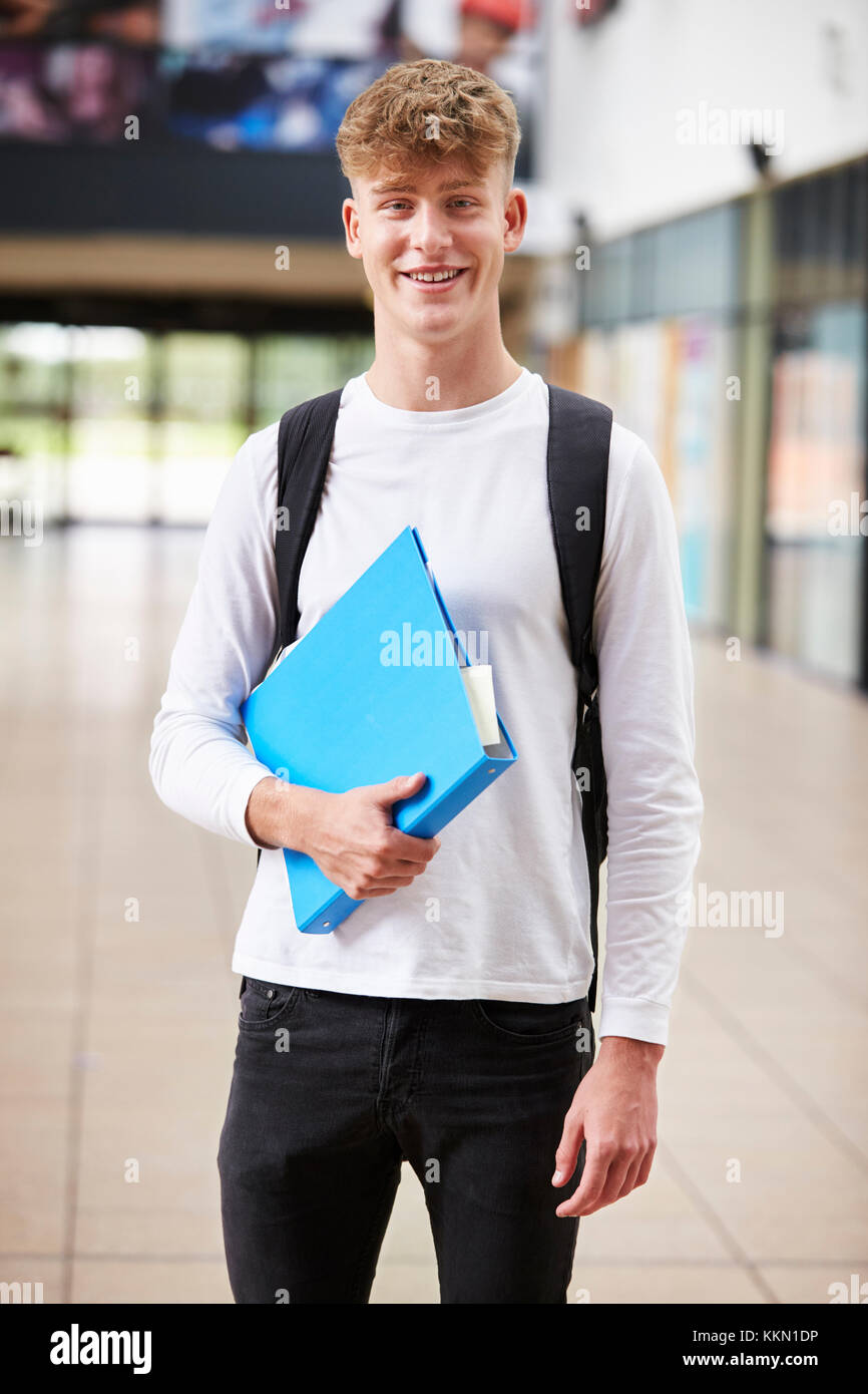 Portrait Of Male Student Standing In College Building Stock Photo