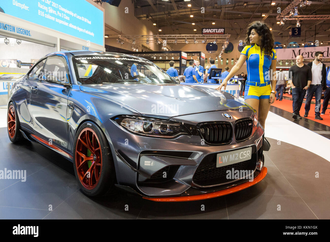 Essen, Germany. 1 December 2017. Female model posing with a BMW. The 2017 Essen Motor Show opens. More than 500 exhibitors are showcasing sporty production vehicles, tunining, motorsport and classic cars. 2017 marks the 50th anniversary of the motor show in Essen which will run until 10 December. Stock Photo