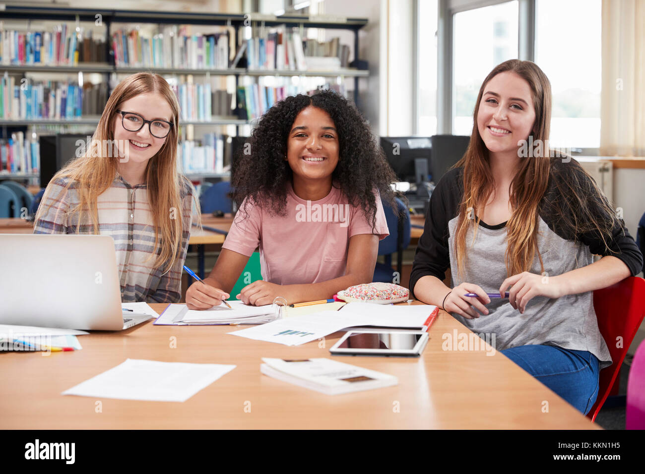 Portrait Of Female College Students Working In Library Together Stock Photo