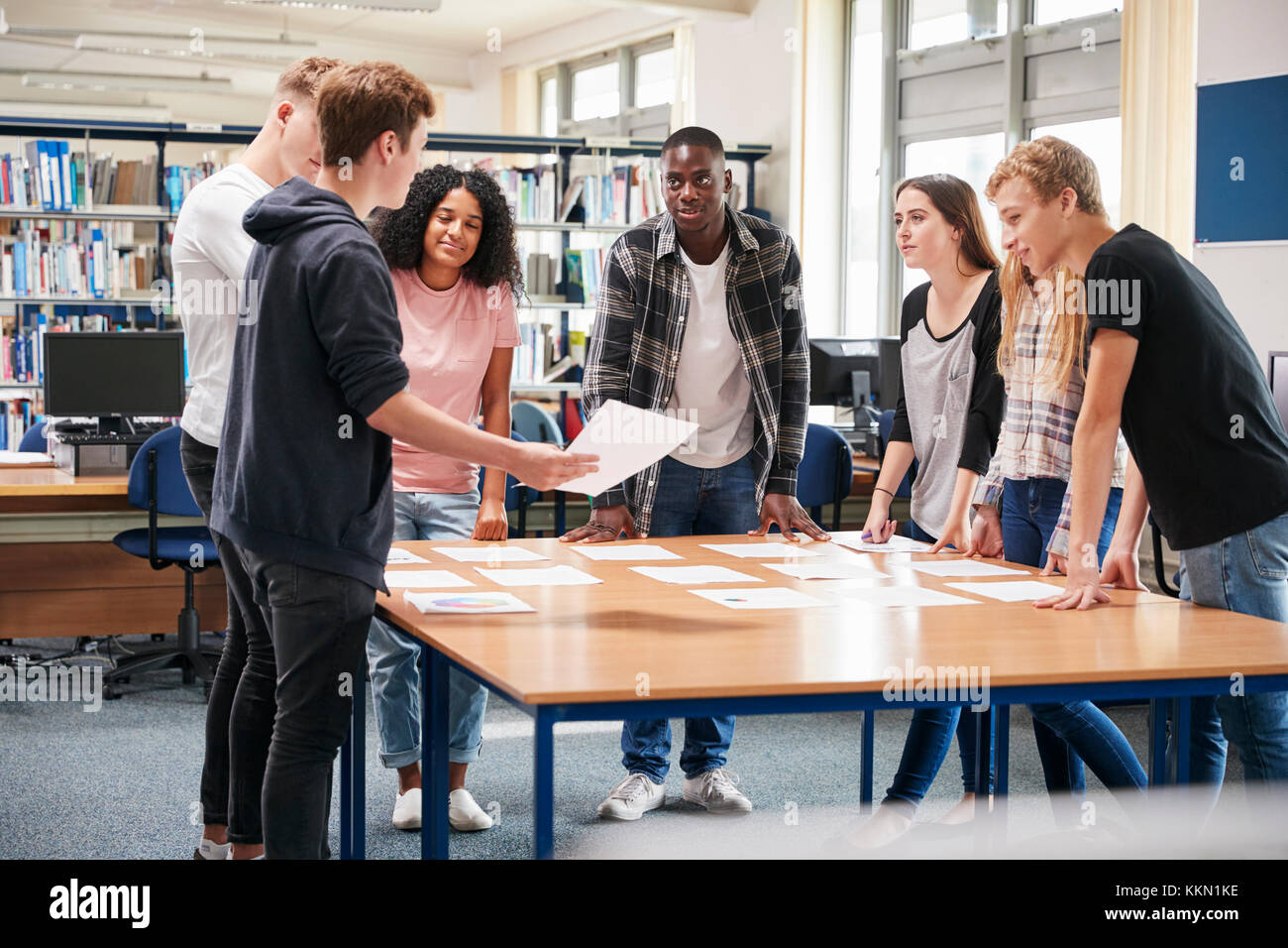 Group Of College Students Collaborating On Project In Library Stock Photo