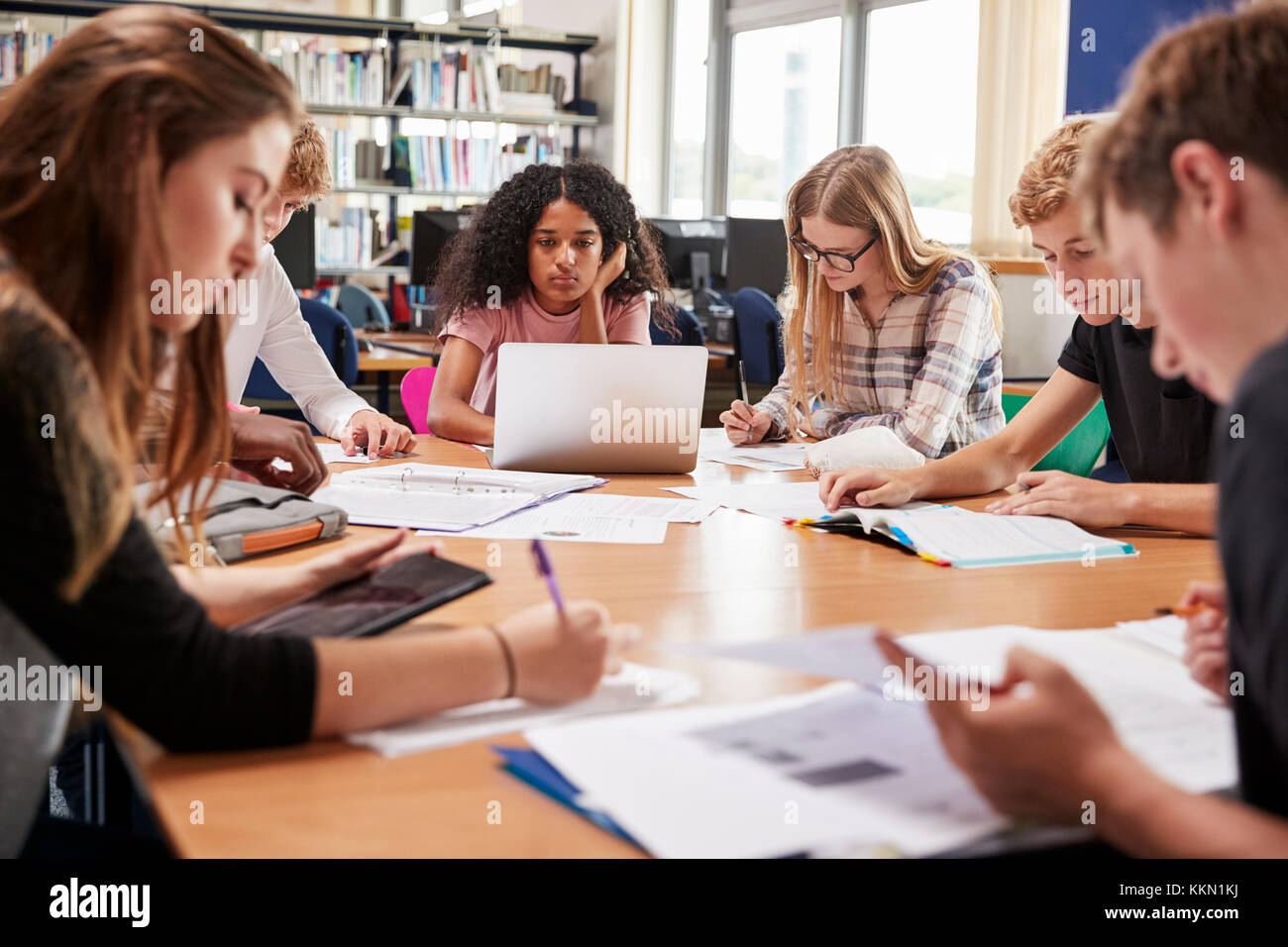 Group Of College Students Working Around Table In Library Stock Photo