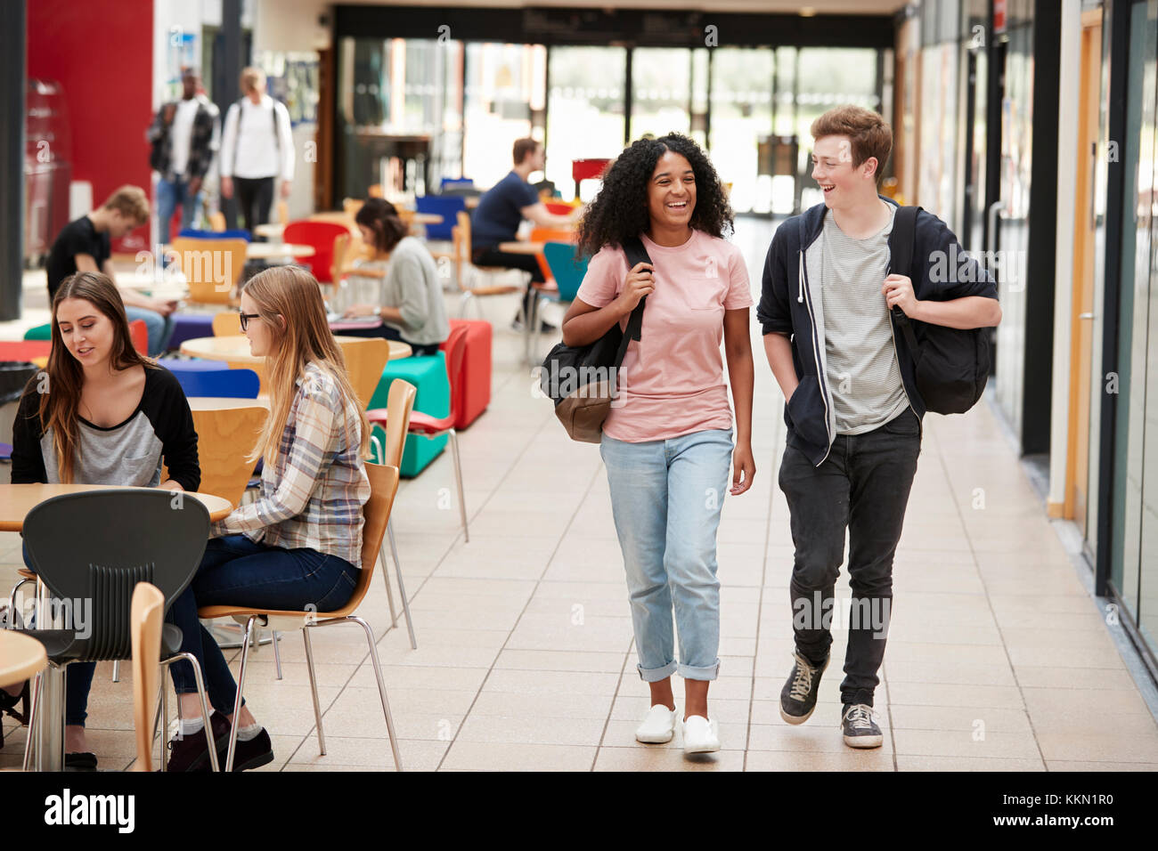 Communal Area Of Busy College Campus With Students Stock Photo