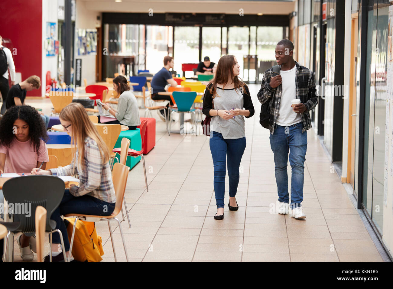 Communal Area Of Busy College Campus With Students Stock Photo