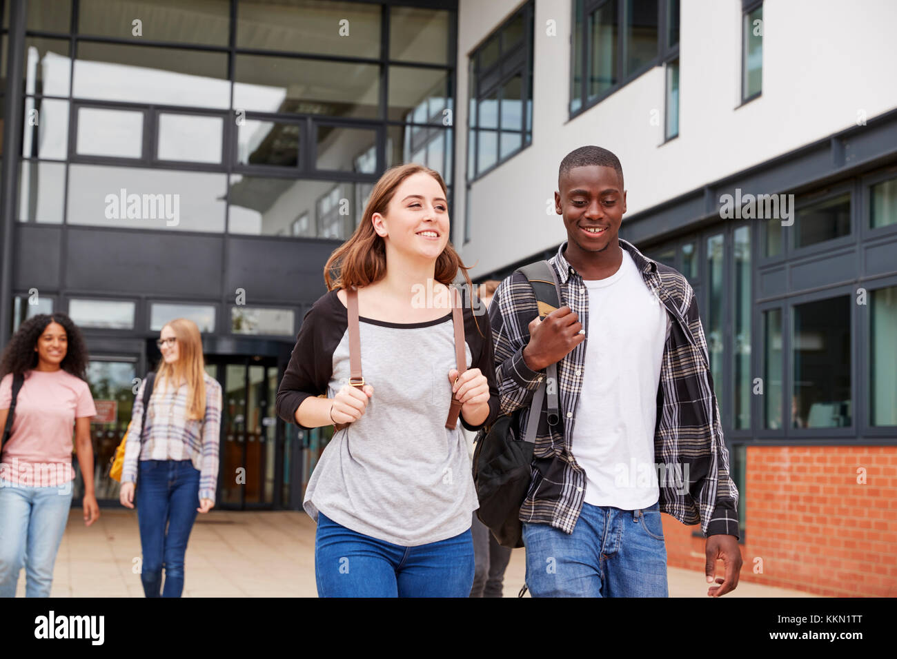 Group Of Students Walking Outside College Buildings Stock Photo