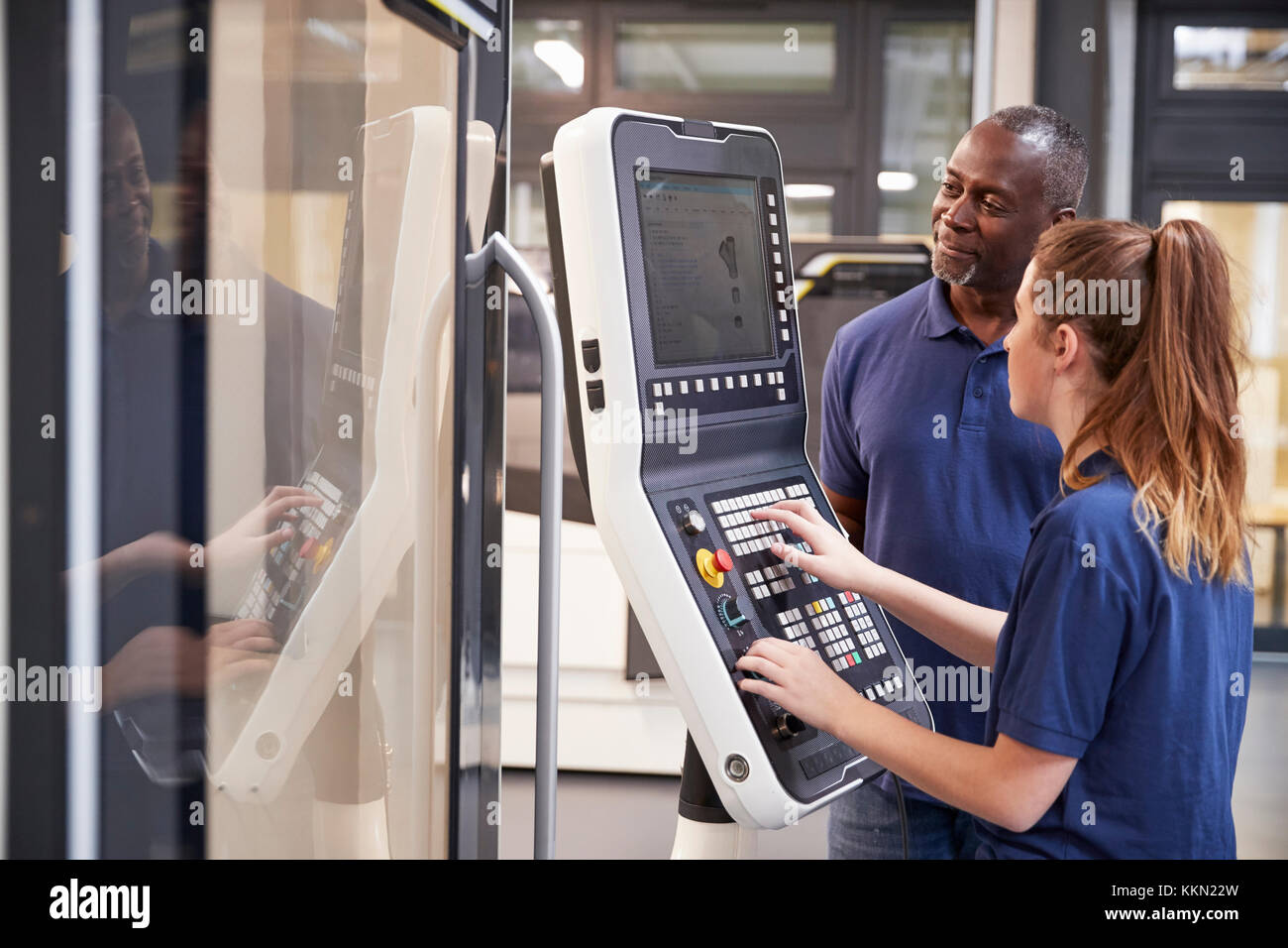 Engineer Showing Apprentice How To Use CNC Tool Making Machine Stock ...