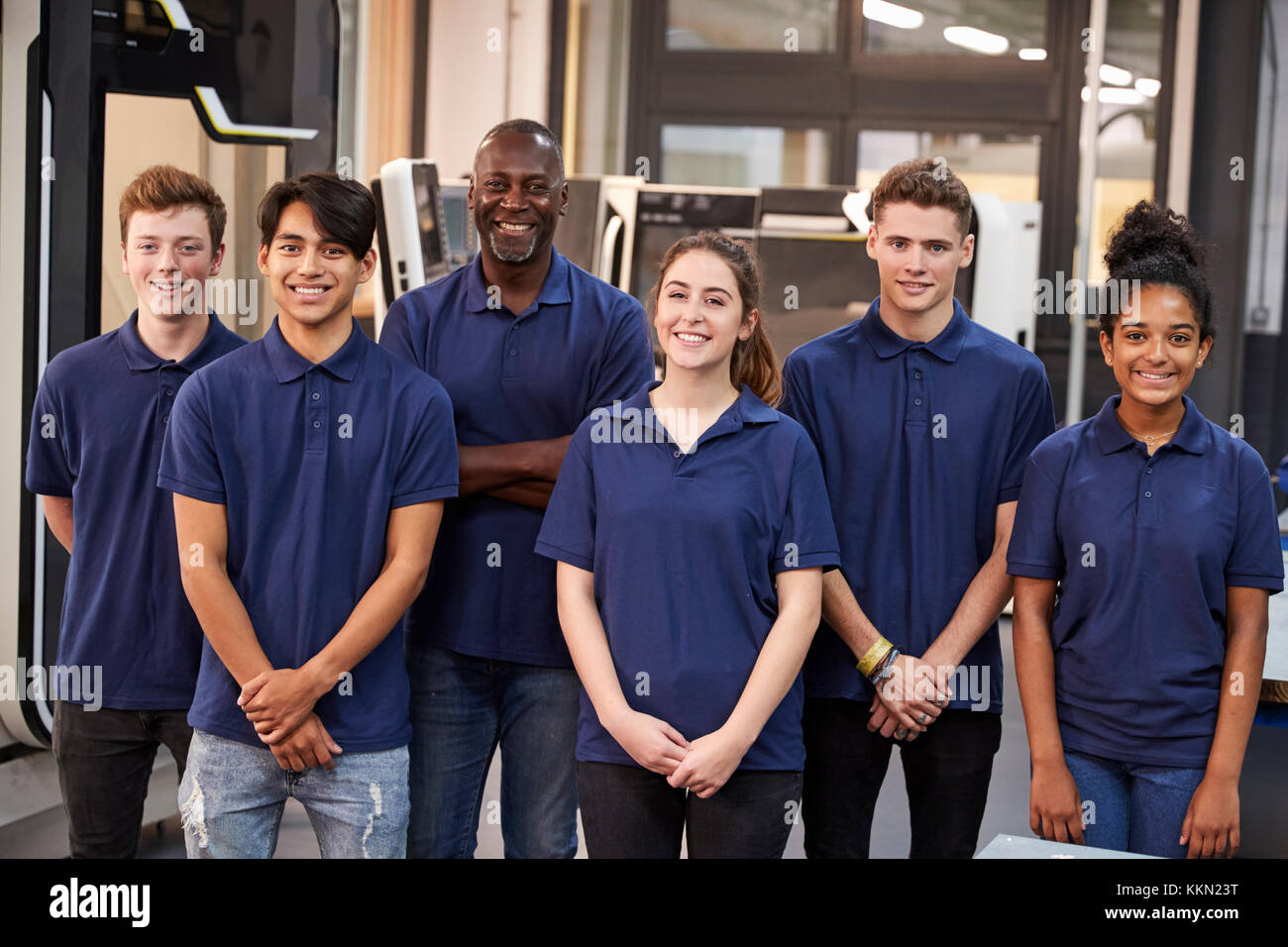 Portrait Of Engineer And Apprentices In Factory Stock Photo