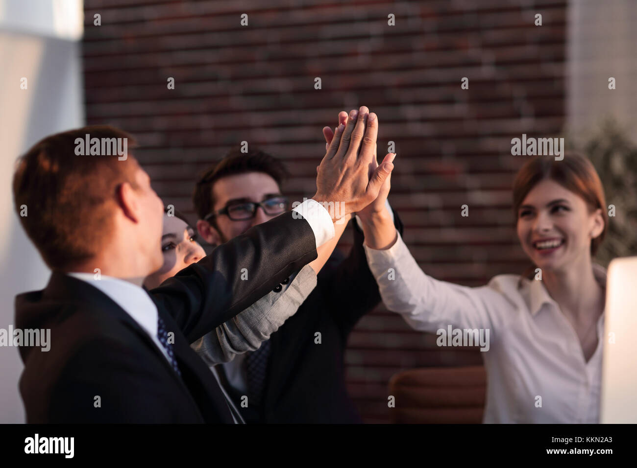 successful business team giving each other a high five Stock Photo - Alamy