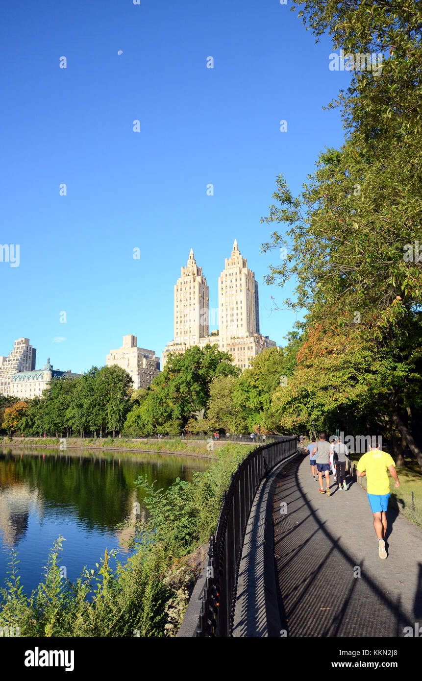 Joggers run around the Schuman Running Track in Central Park with The