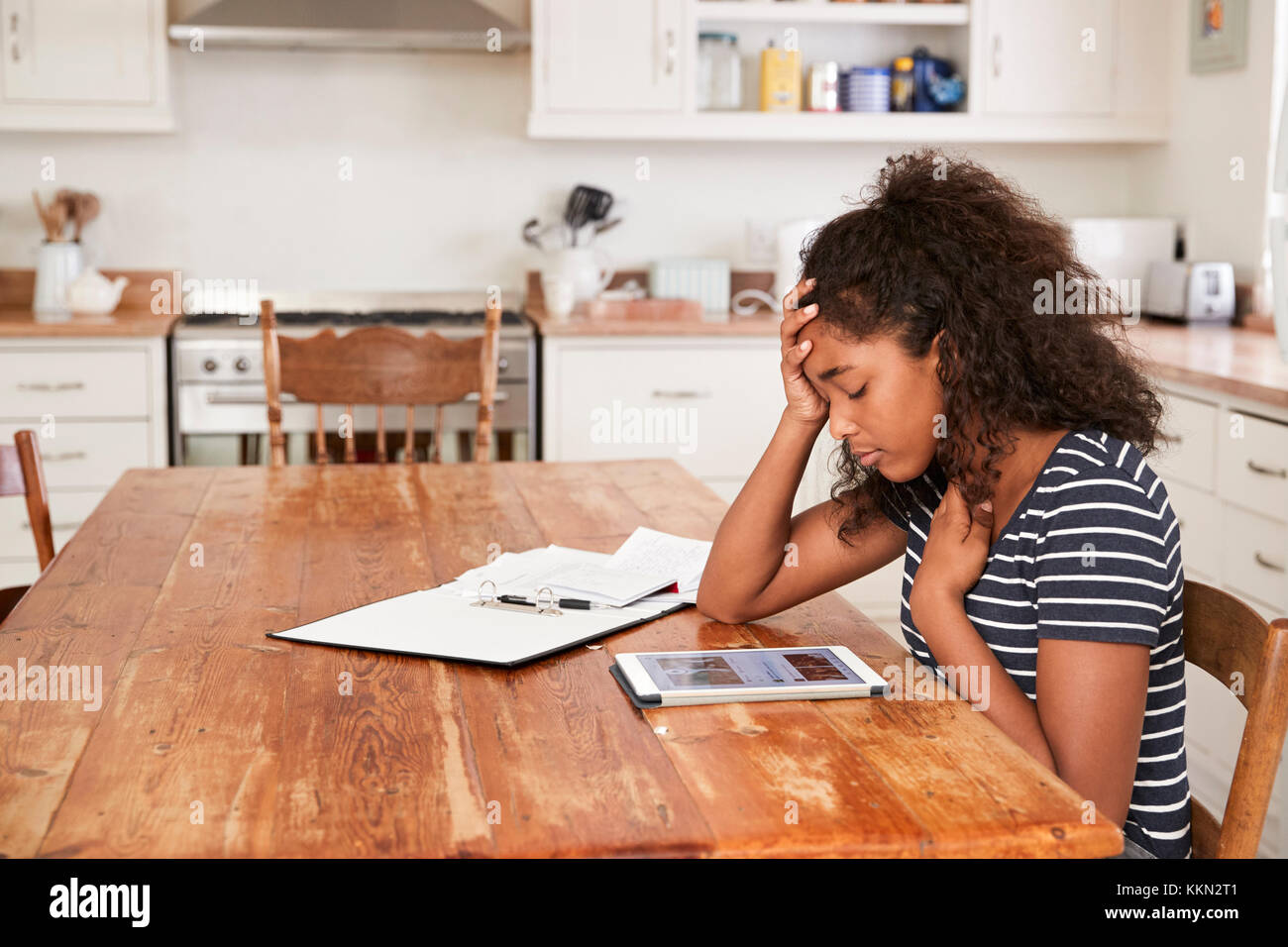 Teenage Girl At Home Using Digital Tablet Being Bullied On Line Stock Photo