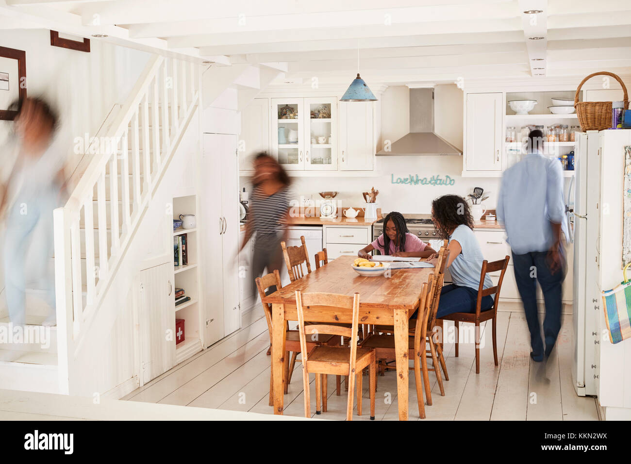 Interior Of Busy Family Home With Blurred Figures Stock Photo